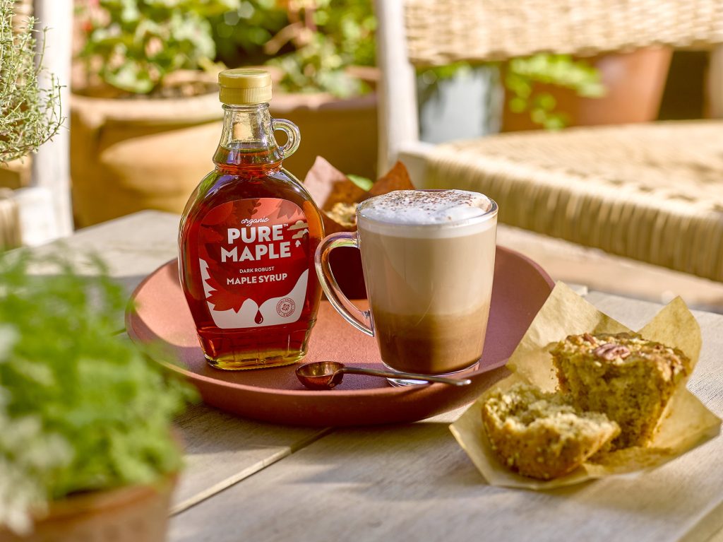 Pure Maple Syrup alongside a Frothy Coffee and Muffin