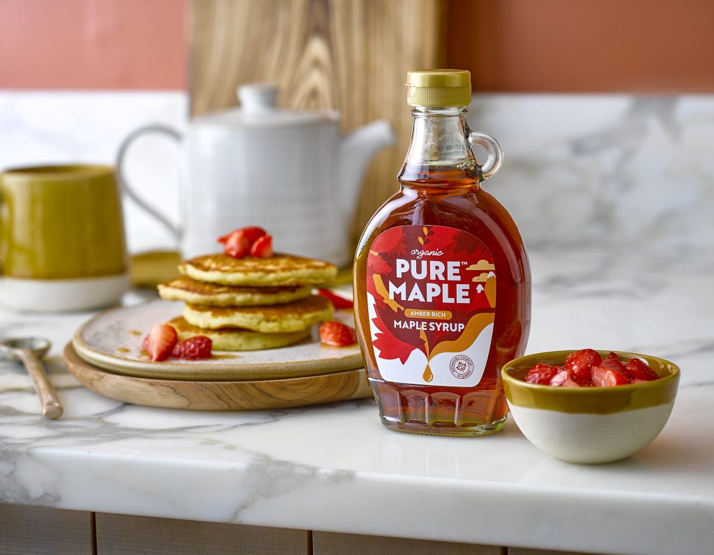 Pure Maple Syrup with a Stack of Pancakes and Strawberries