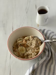 Peanut butter and banana porridge with mixed seeds and maple syrup